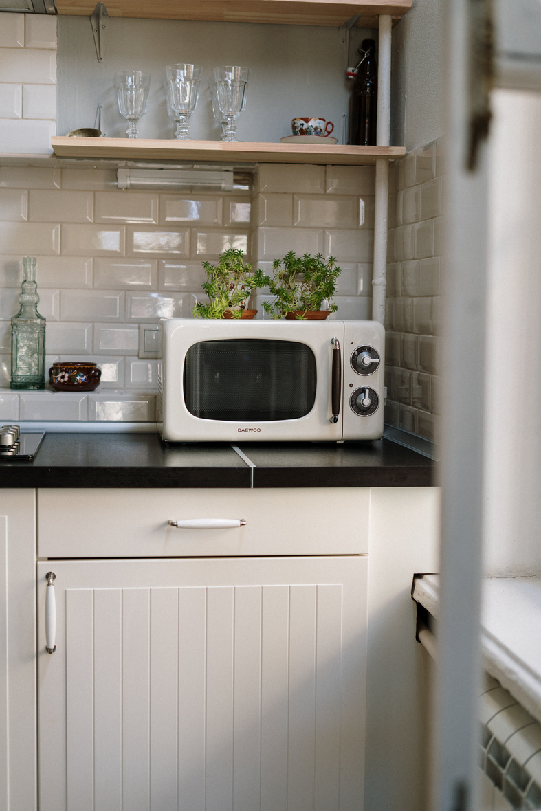 Silver Microwave Oven on White Wooden Cabinet